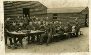 Frank Ward - sitting on bench farthest from hut, 2nd from left